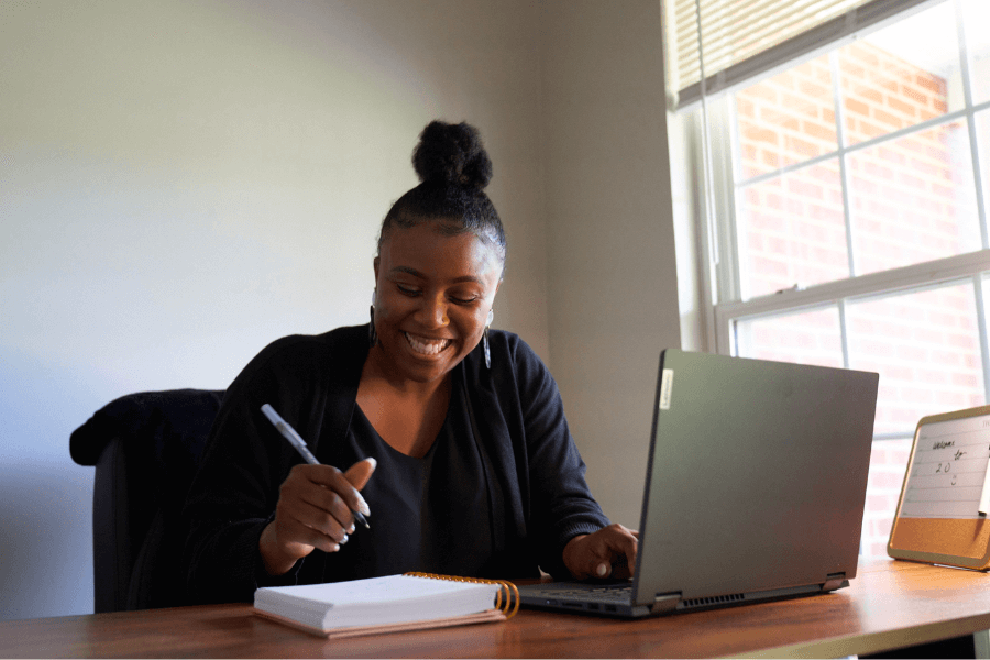 A clinician looking at her laptop