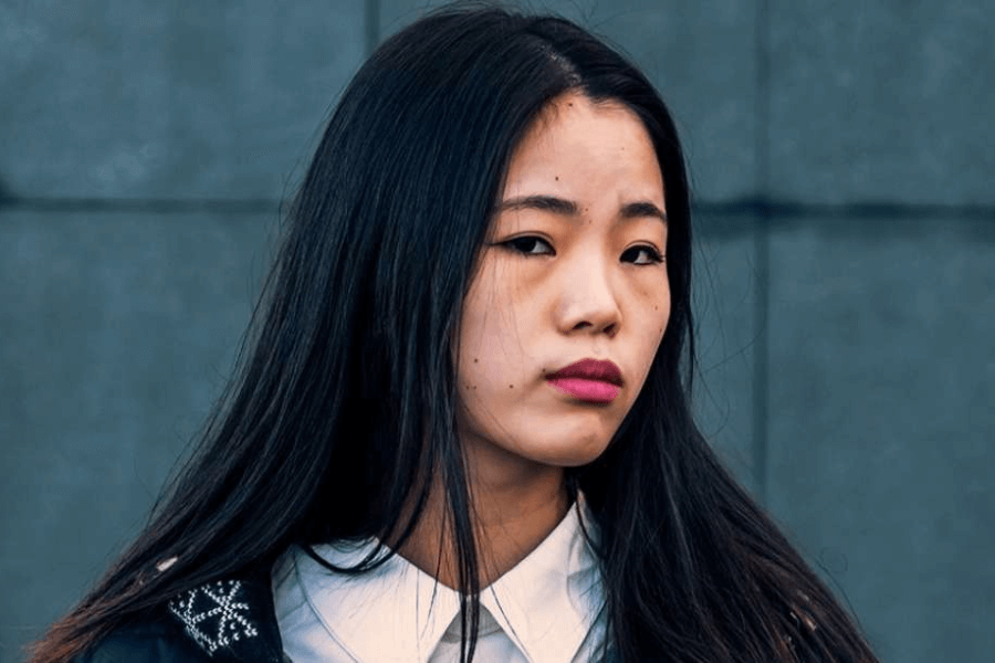 An teenage asian female looking at the camera