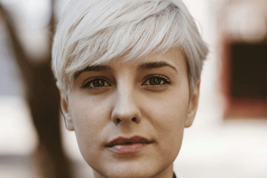 A young woman looks comfortable staring at the camera