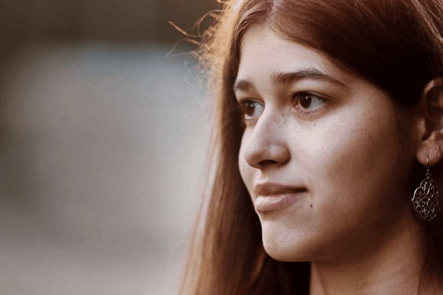 A teen girl looking somewhere on the left