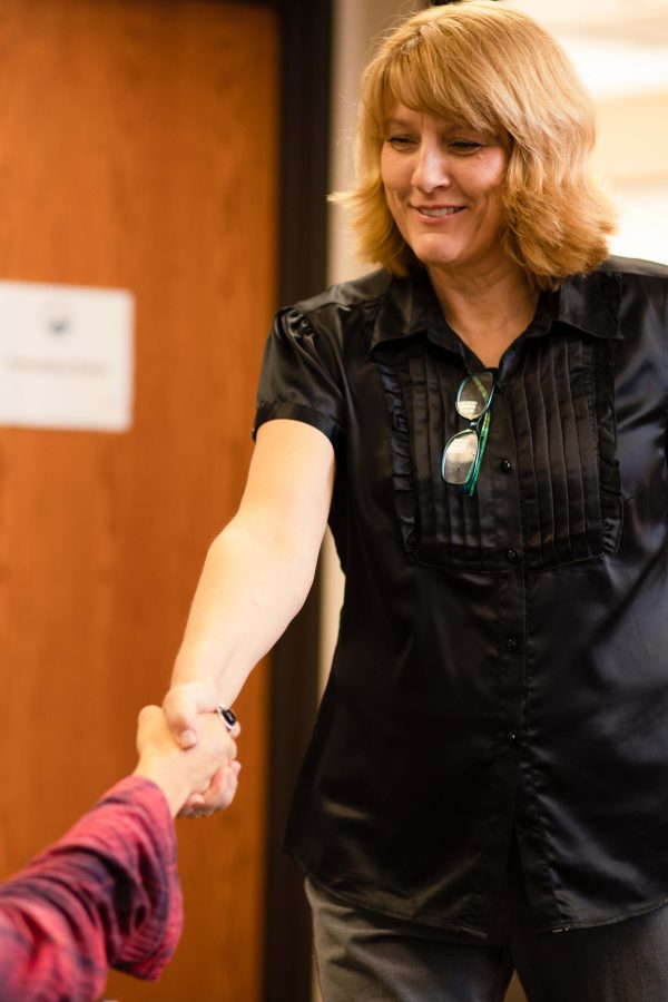 Woman shaking someone's hand