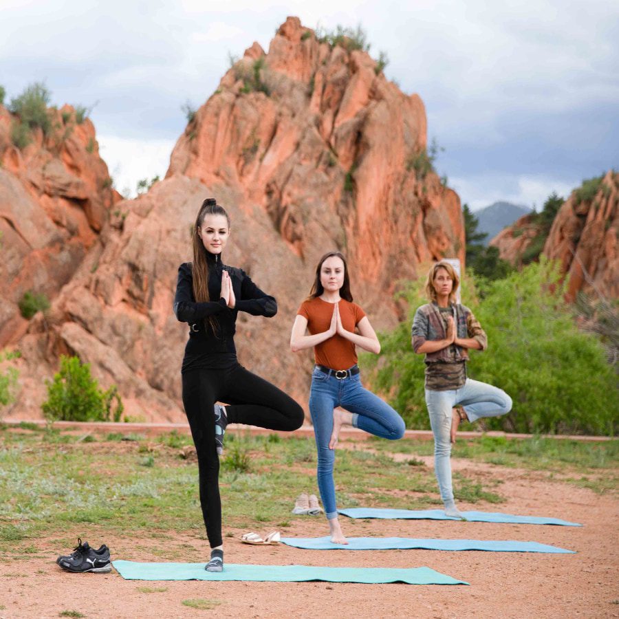 Young adults doing yoga outdoors