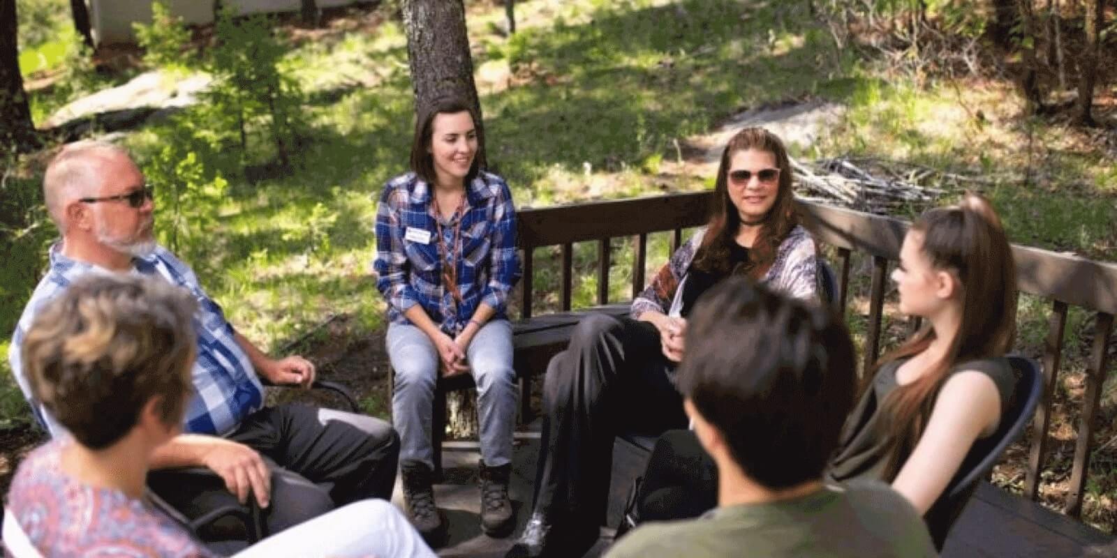 Group of people in the woods conducting therapy session