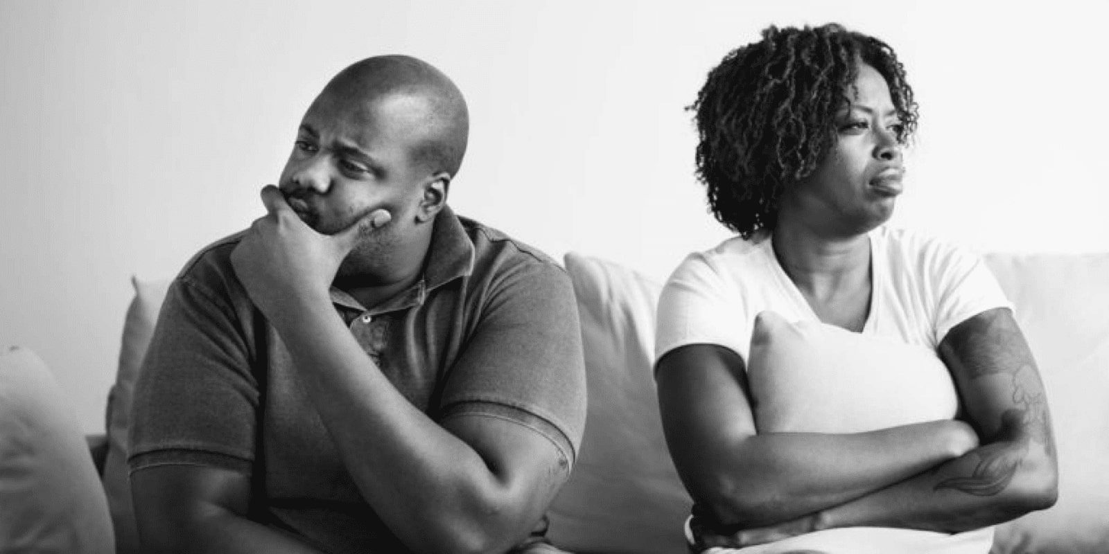 A disturbed couple facing away from each other