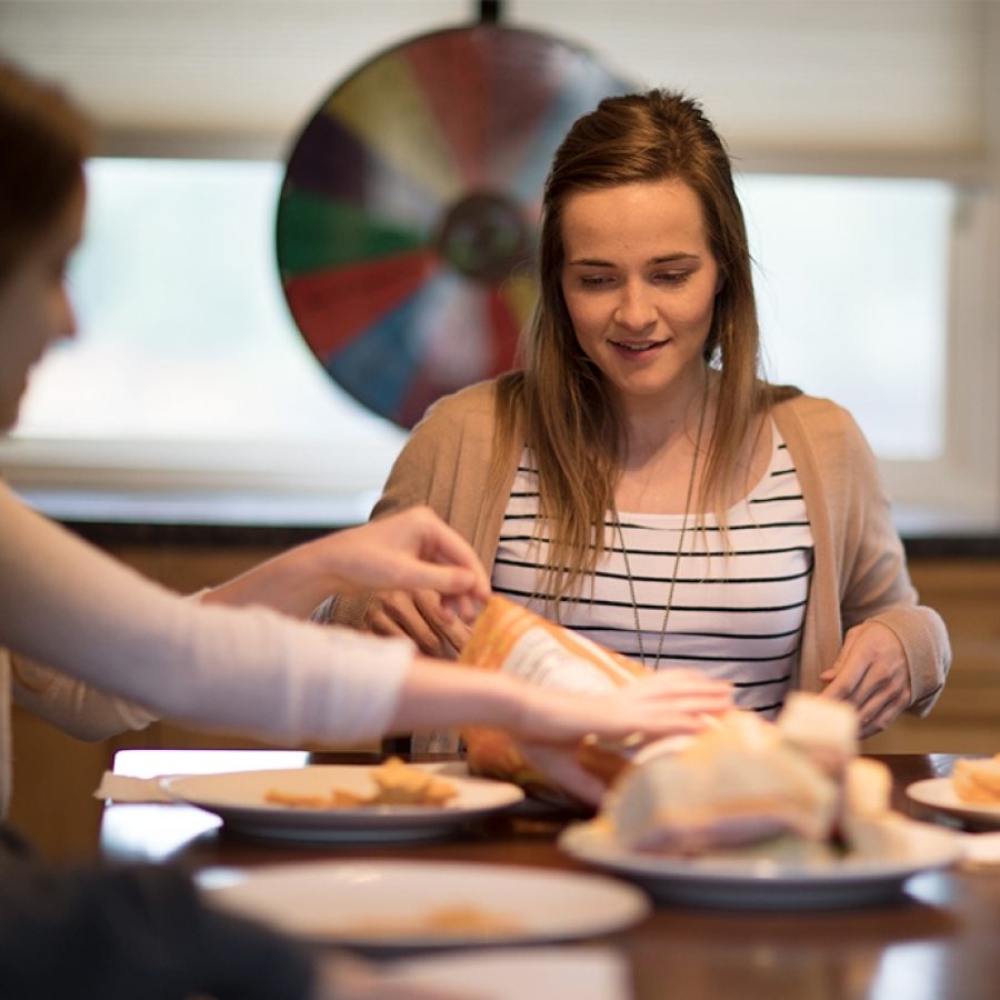 Young woman smiling during meal with others