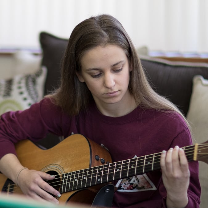 teen playing guitar