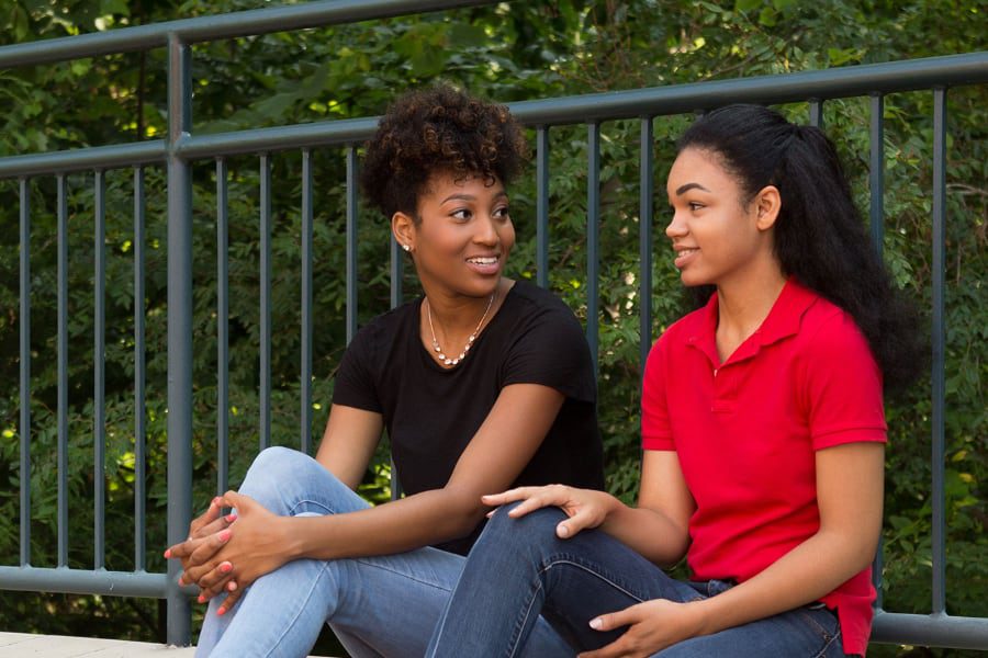 two students talking outside