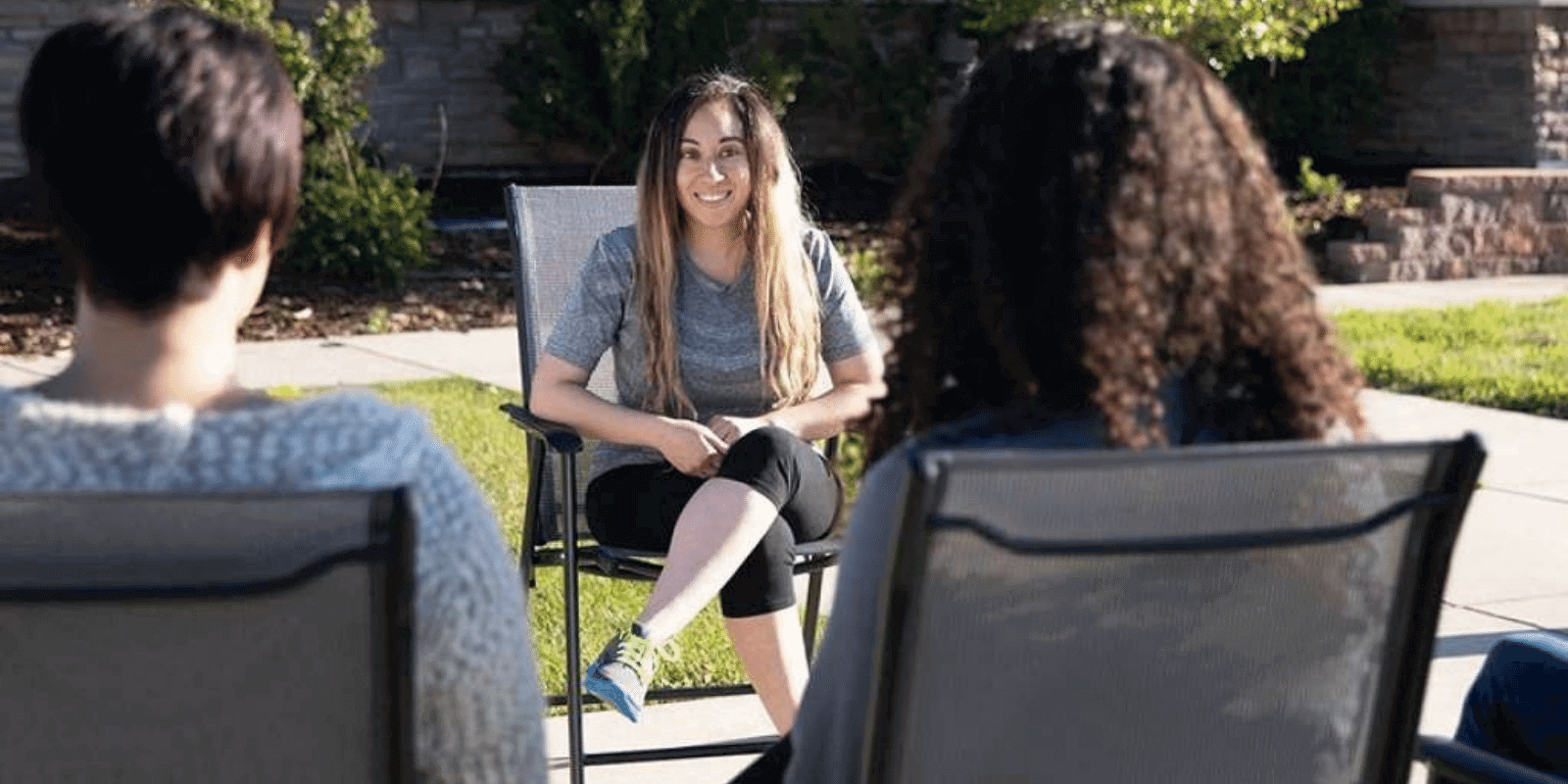 Young adult talking cheerfully to her peers