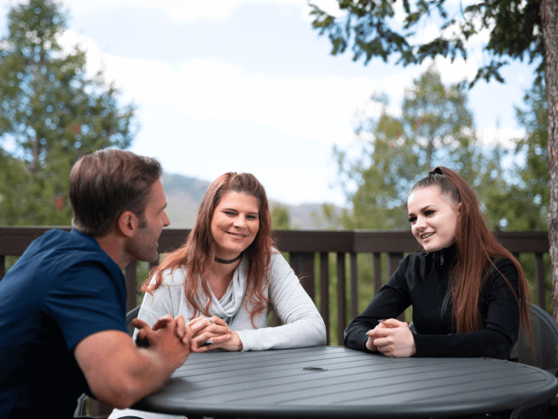 A therapist talking to teen and her mom