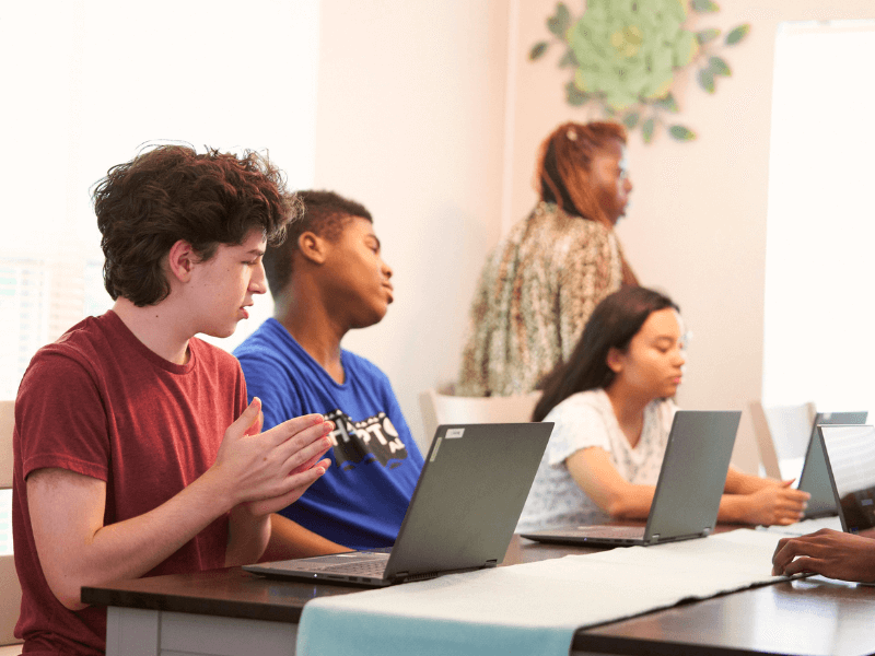 Teens studying together with a tutor