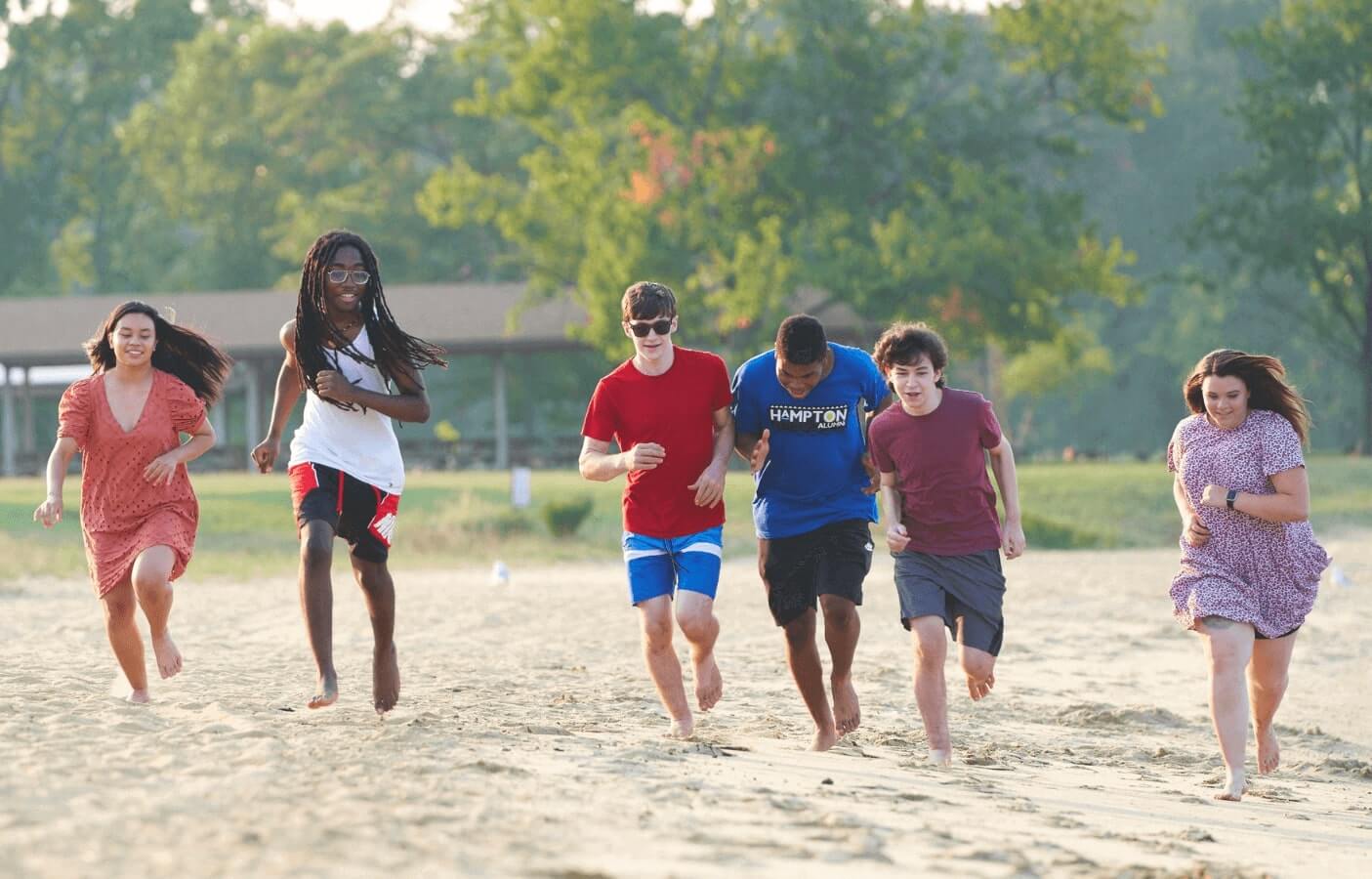 Teens running down the beach in partial hospitalization program