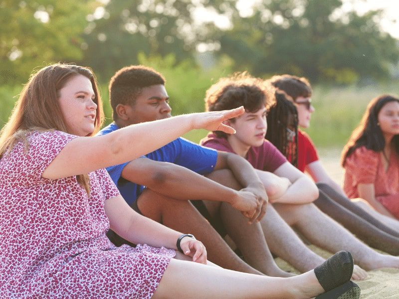 Teens sitting on the beach