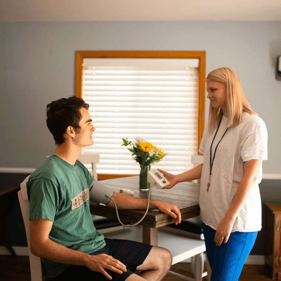 A teen boy measuring blood pressure