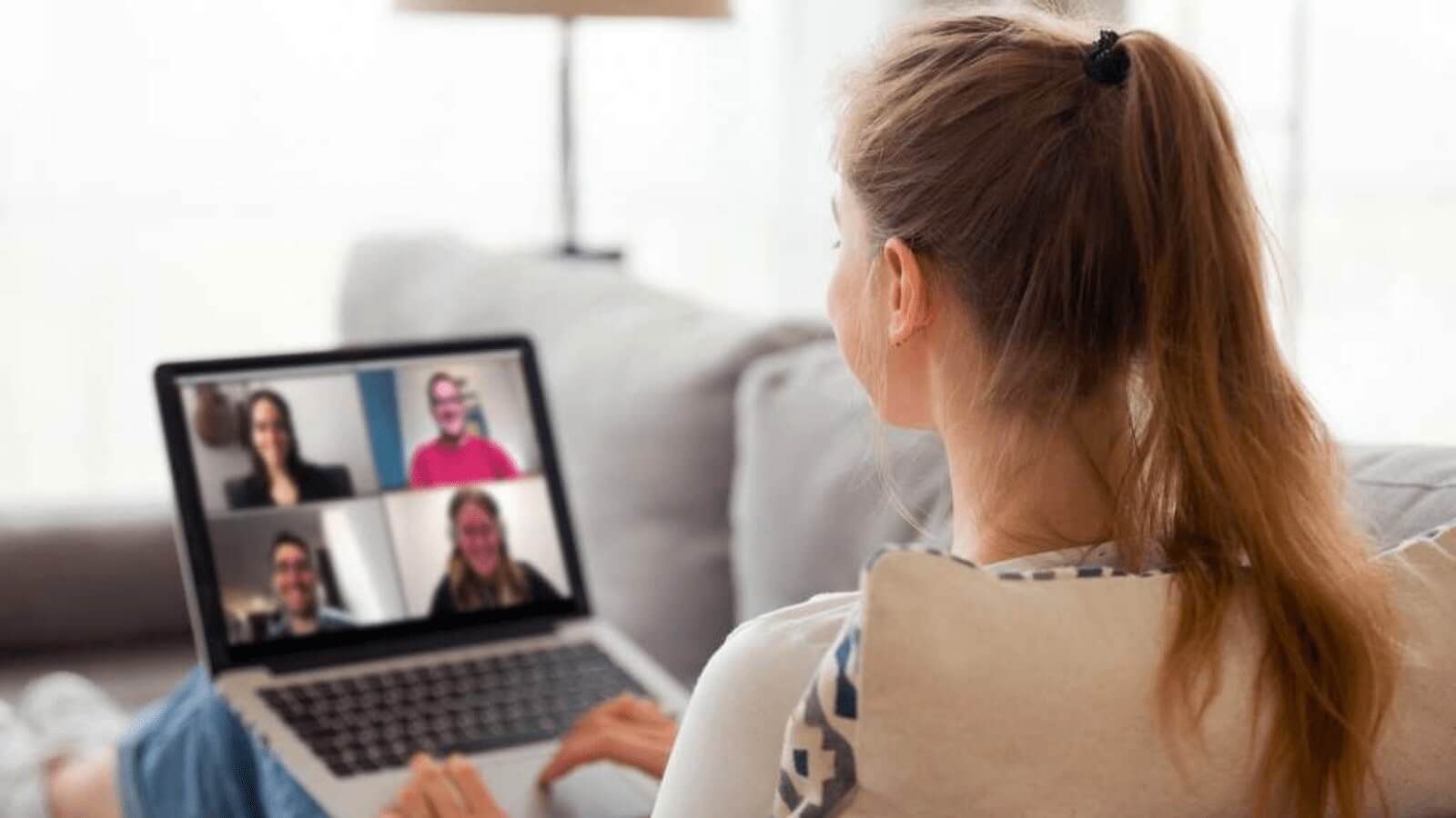 woman on couch using computer