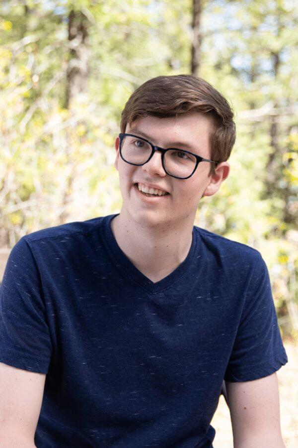 Teenage boy smiling in the forest