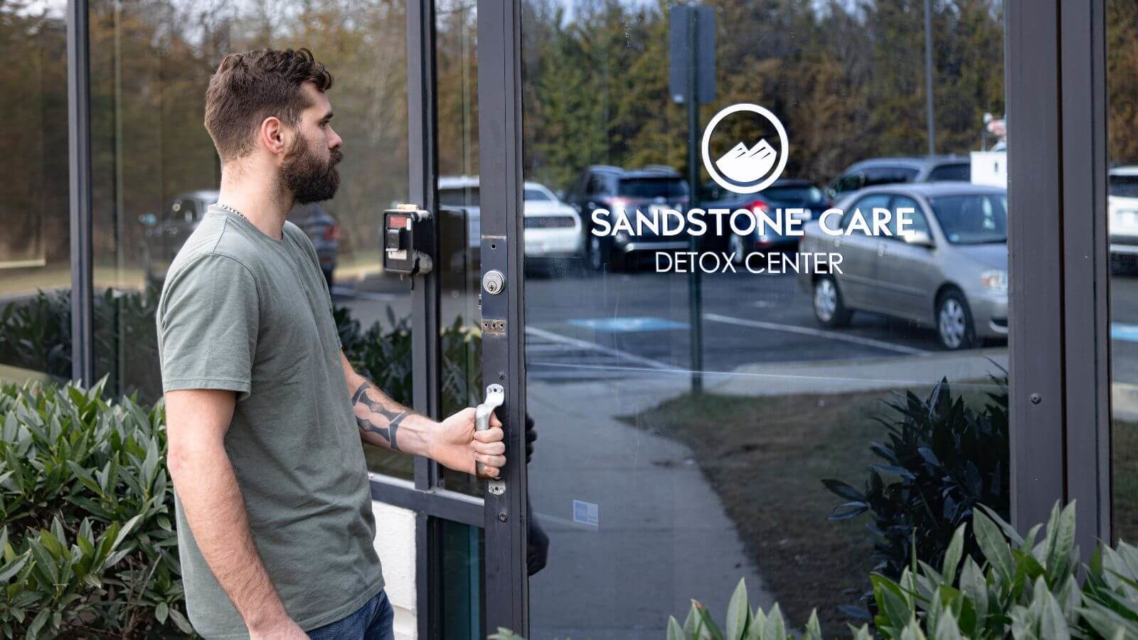 A client opening the door of Sandstone Care Virginia Detox Center