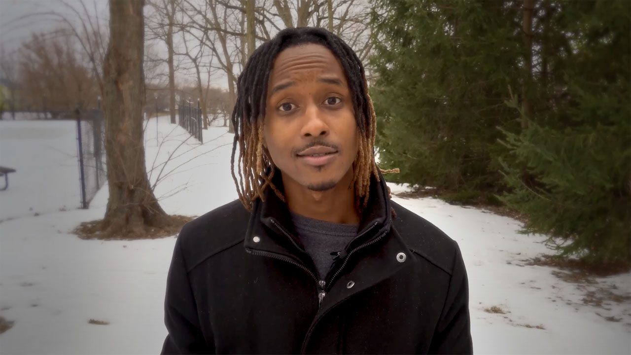 A young man standing outside in the winter.